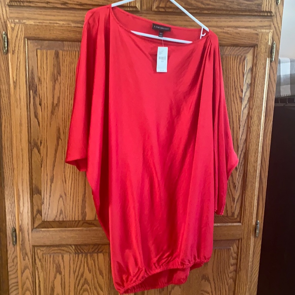 Red new with tags tunic length top.Batwing sleeves